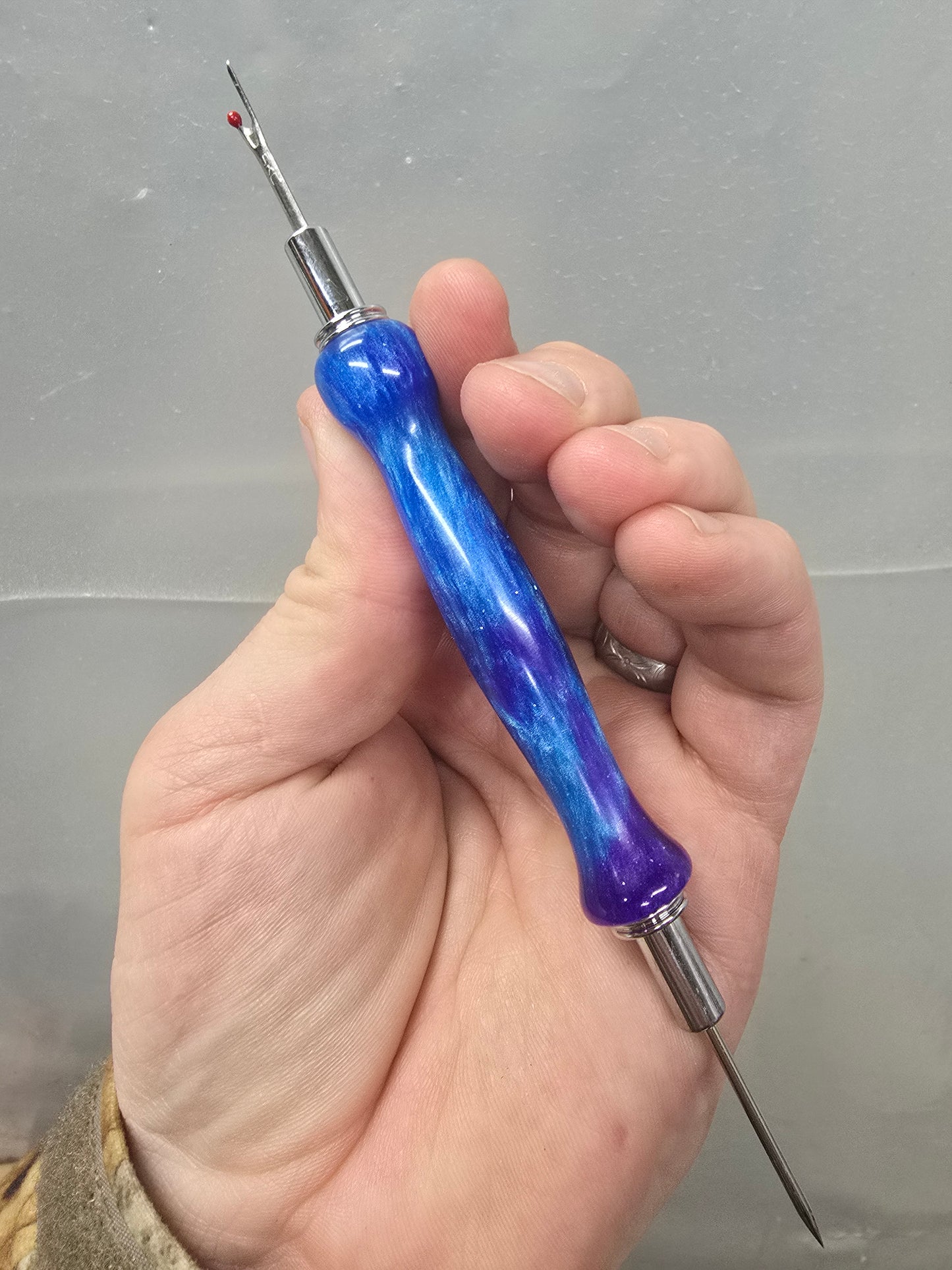 Blue and purple sewing seam ripper and stiletto combo tool